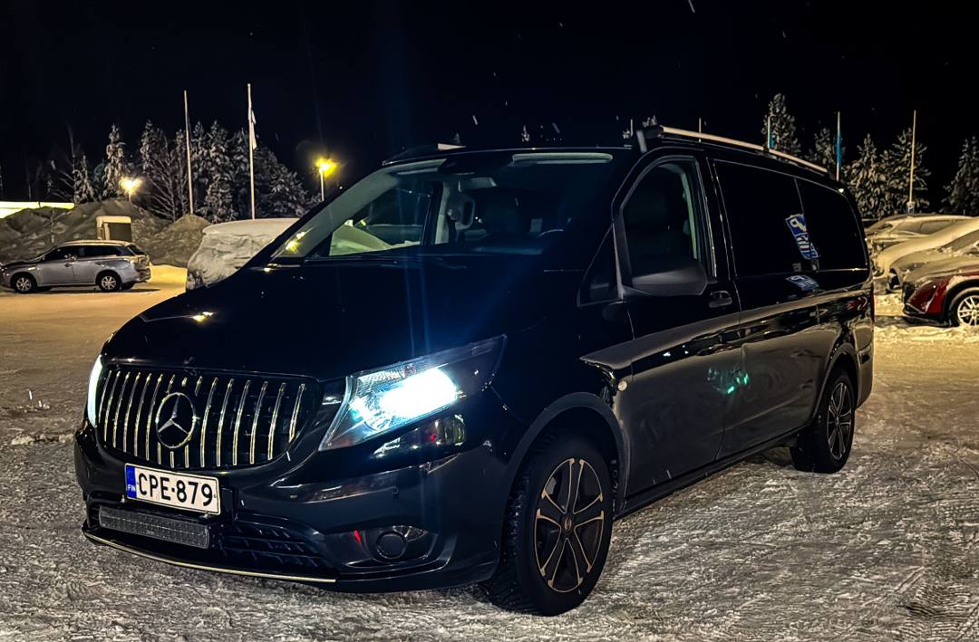 Black Mercedes-Benz van in a snowy car park at night